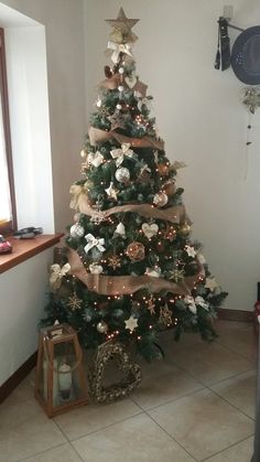 a decorated christmas tree in the corner of a room