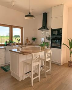 a kitchen with white cabinets and an island in the middle is featured on instagram