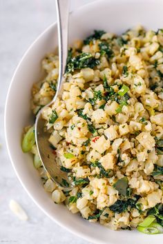 a white bowl filled with rice and vegetables