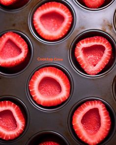 cupcake tins filled with fresh strawberries in the shape of heart shaped holes