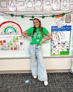 a woman standing in front of a bulletin board