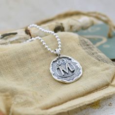 An initial or monogram is a sign of identity. Wear it to show off your own beautiful identity or wear several to show off those who have created a lasting impression in your heart. Our Lasting Impressions Necklace comes to you in handcrafted sterling silver and on a 16" chain. If you prefer a longer length, you can select 18, 20, 24 or 30 inches for a small additional fee. This designer monogram necklace replicates the the lost art of wax seals to identify the writer. Each silver monogram is cre Personalized Sterling Silver Initial Necklace, Silver Monogram Jewelry For Everyday, Everyday Silver Monogram Jewelry, Classic Sterling Silver Charm Necklaces With Initials, Sterling Silver Medallion For Personalized Gift, Silver Initial Pendant Necklace For Everyday, Silver Custom Necklace With Initial Pendant For Everyday, Personalized Medallion Jewelry In Sterling Silver, Personalized Sterling Silver Medallion Jewelry