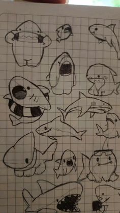 a drawing of different types of fish on a piece of paper with graph paper in front of it