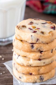 a stack of cookies next to a glass of milk