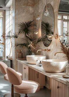 two sinks in a bathroom with mirrors and plants on the wall next to each other