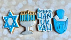 three decorated cookies with the words happy hanukkah on them