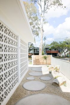 an outdoor area with stepping stones and a tree