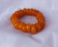 Handmade Orange Bead Stretch Bracelet, Handmade Spiritual Orange Stretch Bracelet, Handmade Orange Stretch Bracelet With Round Beads, Orange Stretch Bracelet With Large Beads As Gift, Gift Orange Stretch Bracelet With Large Beads, Orange Stretch Bracelet With 8mm Beads, Adjustable Amber Bracelet With Large Beads, Adjustable Amber Bracelets With Large Beads, Adjustable Orange Stretch Bracelet With Round Beads