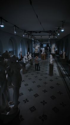 a room filled with lots of statues and lights