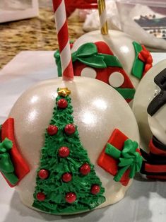 two decorated christmas ornaments sitting on top of a table