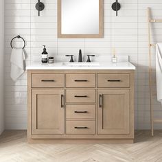 a bathroom vanity with two sinks and a mirror