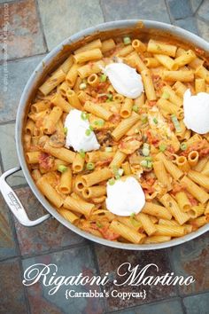 a pot filled with pasta and cheese on top of a table