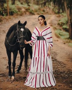 This traditional Shimena Oromo dress is a true beauty, inspired by the intricate designs of Karayu culture. Made from high-quality Suf fabric, this dress exudes elegance and sophistication. The dress's full Shimena adds a regal touch, making it perfect for formal occasions. The carefully selected accessories complement the dress's beauty, enhancing its overall elegance. This dress is not only a celebration of Oromo culture but also a tribute to the beauty and richness of traditional Ethiopian fa Elegant Maxi Dress With Traditional Patterns For Ceremonies, Elegant Maxi Dress With Traditional Patterns, Elegant Long Sleeve Maxi Dress With Traditional Patterns, Traditional Patterned Dresses For Summer Ceremonies, Summer Dresses With Traditional Patterns For Ceremonies, Elegant Dresses With Woven Motifs For Wedding, Elegant Wedding Dress With Woven Motifs, Elegant White Maxi Dress With Traditional Patterns, Elegant Summer Dresses For Traditional Ceremonies