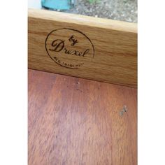 a wooden bench with the word brexel engraved on it's back side