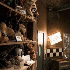 a creepy looking room with shelves full of stuffed animals and other stuff on the walls