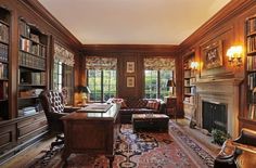 a living room filled with lots of furniture and bookshelves next to a fire place