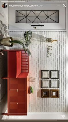 an overhead view of a living room with red furniture and pictures on the wall behind it