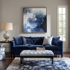 a living room filled with furniture and a painting on the wall