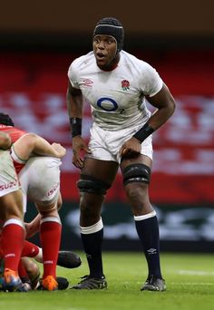 a rugby player is standing on the field