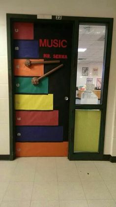 an open door with music on it in a school hallway next to a white tiled floor