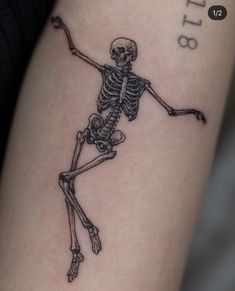 a skeleton tattoo is shown on the arm and leg, with an inscription below it