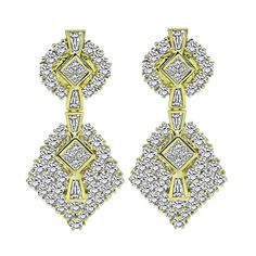 This is a charming pair of 18k yellow gold dangling earrings from the 1970s. The earrings feature sparkling round, baguette and princess cut diamonds that weigh approximately 10.00ct. The color of these diamonds is H-I with VS clarity. The earrings measure 45mm by 21mm and weigh 26.1 grams. The earrings are stamped 18K.