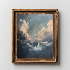 an oil painting on canvas of clouds in the sky with gold frame hanging on wall