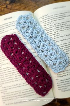 two crocheted book ends sitting on top of an open book