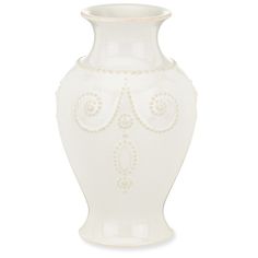 a white vase with an ornate design on it