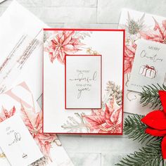 christmas cards with poinsettis and red flowers on white marble background, holiday greeting card