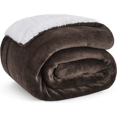 a blanket that has been rolled up on top of each other with a white pillow