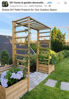 an outdoor garden with wooden planters and flowers