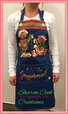 a woman wearing an apron with gingerbread cookies on it and the words i love gingerbread