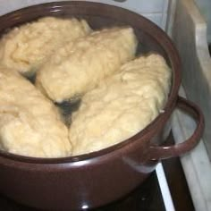 a pot filled with dough sitting on top of a stove