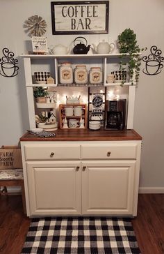 a coffee bar with white cabinets and black and white checkered rug