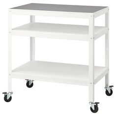 a white cart with two shelves and wheels on the bottom one shelf is holding a gray top