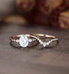 two gold rings with white diamonds on them