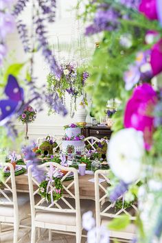 a dining room table covered in lots of purple flowers