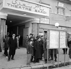 an old black and white photo of people standing in front of the theater saadi