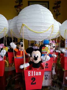 mickey mouse in a box with paper lanterns attached to it