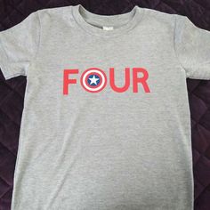 Gray Shirt With "Four" In Red Letters And Captain America Shield For The Letter "O" Also Available In "One" And "Two" Also Available In White T Shirt 100% Cotton T-Shirt Machine Wash Cold Inside Out, Hang To Dry Red Letters, Captain America Shield, Gray Shirt, Letter O, Grey Shirt, Birthday Shirt, 4th Birthday, White T Shirt, Birthday Shirts