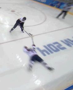 two hockey players on the ice during a game