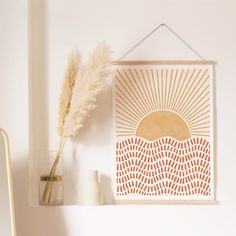 a white shelf with a vase, mirror and art work hanging on it's wall