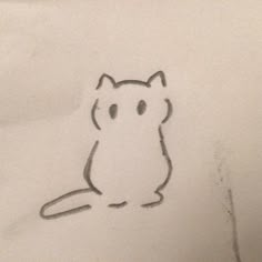 a drawing of a cat sitting on top of a white sheet with black ink in it