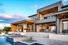 a large house with a pool in front of it