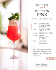 a pink cocktail with mint garnish on the rim