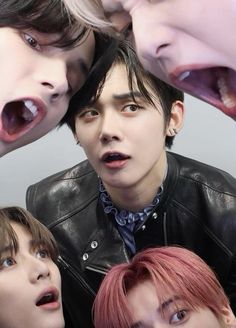 four young men with their mouths open in front of them, all wearing black leather jackets