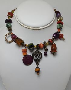 This great signed necklace by Treska is incredibly unique both in quality and appeal. It has tiered pendanta and great beadwork. It measures about 16" in total length with the center pendant measuring about 2 1/2" down. The beading covers about 9 1/2" along the necklace. It has no apparent damages or repairs Metal Necklace With Large Beads For Gift, Unique Dangle Jewelry With Large Beads, Unique Dangle Earrings With Large Beads, Unique Adjustable Pendant Beaded Necklaces, Unique Adjustable Pendant Beaded Necklace, Unique Adjustable Beaded Pendant Necklace, Eclectic Festival Necklaces With Large Beads, Metal Beaded Necklaces With Large Beads As Gift, Bohemian Czech Glass Necklaces For Gifts