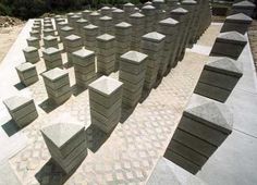 rows of cement blocks sitting on top of a sidewalk