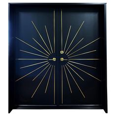 a black and gold door with sunbursts on it